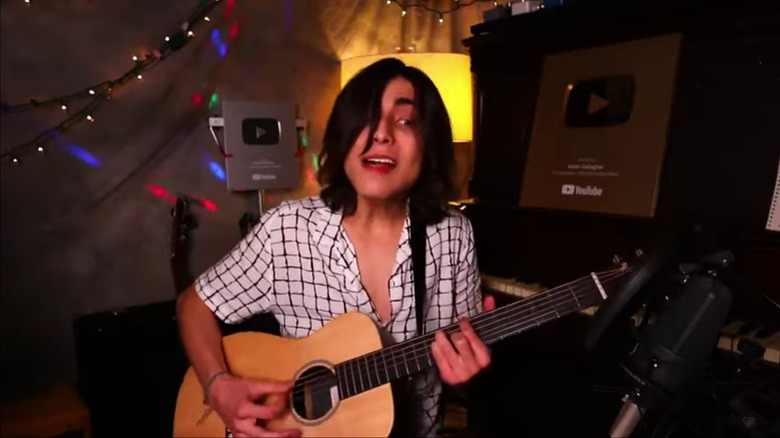 Aidan Gallagher playing guitar