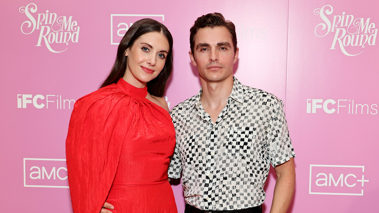 Alison Brie smiling with Dave Franco