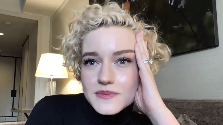 Julia Garner with hand on face