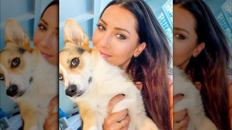 Becca Kufrin holding a Corgi