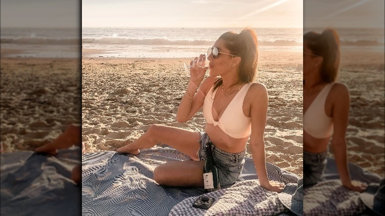 Becca Kufrin drinking wine