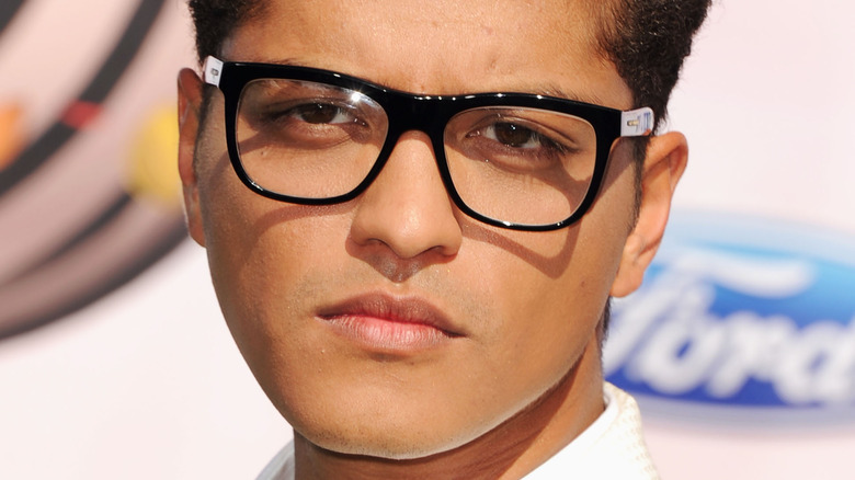 Bruno Mars wearing thick glasses