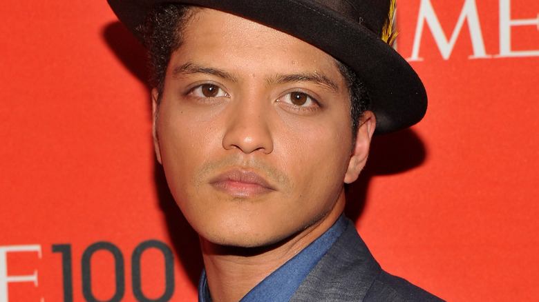 Bruno Mars wearing a gray suit