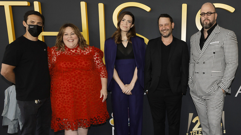 Milo Ventimiglia wearing a mask, Chrissy Metz, Mandy Moore, Dan Fogelman, and Chris Sullivan, smiling