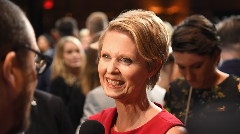 Cynthia Nixon smiling and talking to the press 