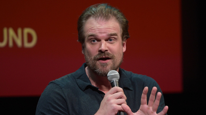 David Harbour speaking into a microphone