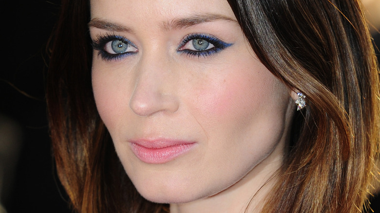 Emily Blunt looking to the side, wearing blue and black eyeliner