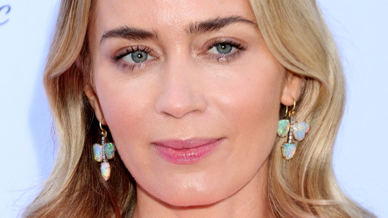 Emily Blunt looking to the side, sparkling dangly earrings