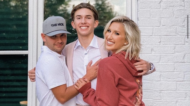 Savannah Chrisley, Chase Chrisley, hugging Grayson Chrisley who is all dressed up for Homecoming