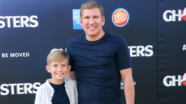 Grayson Chrisley, smiling alongside his dad, Todd Chrisley