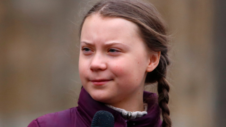 Greta Thunberg in a purple jacket 