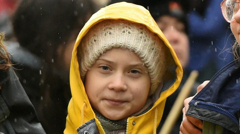 Greta Thunberg in a yellow coat 