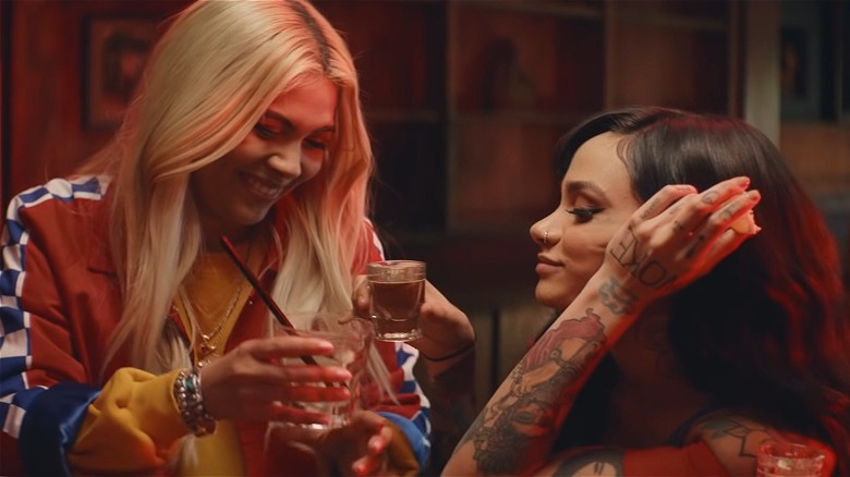 Hayley Kiyoko smiling with Kehlani in "What I Need" music video