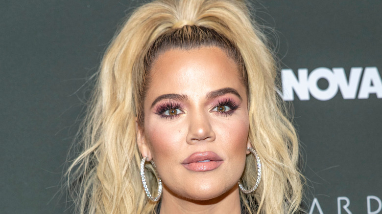 Khloé Kardashian wearing hoop earrings