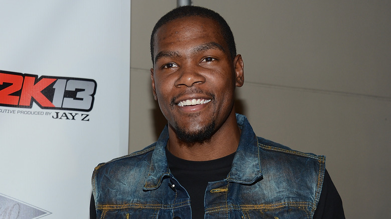 Kevin Durant in a jean jacket, smiling