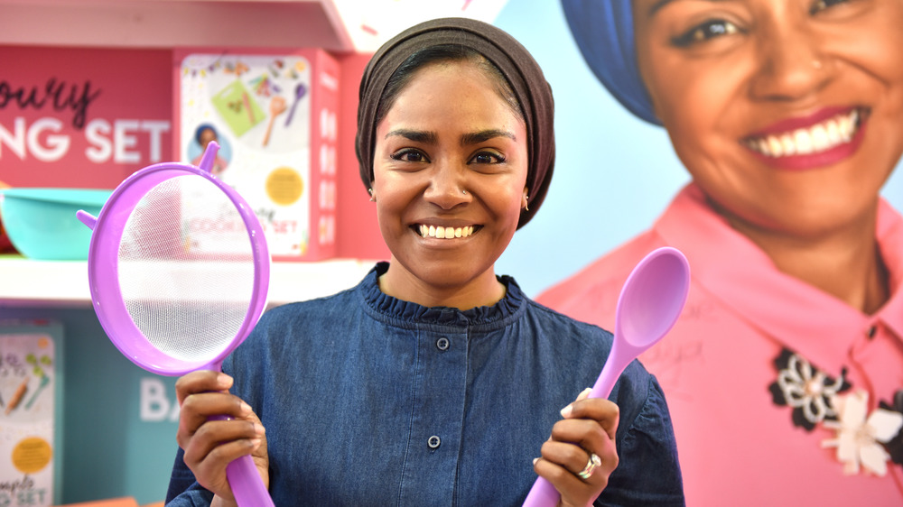 Nadiya Hussain holding toy cookware