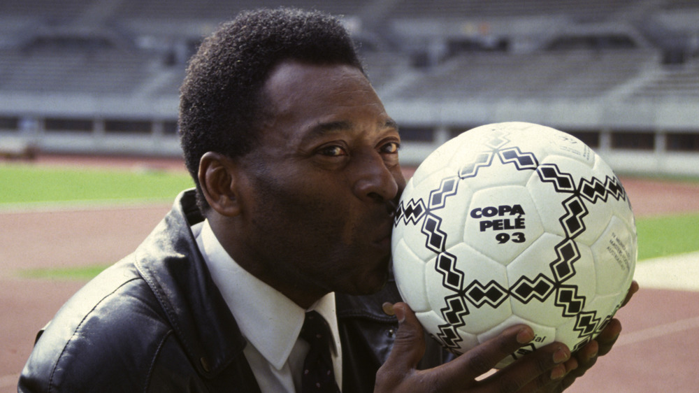 Pele kissing a soccer ball in 1993