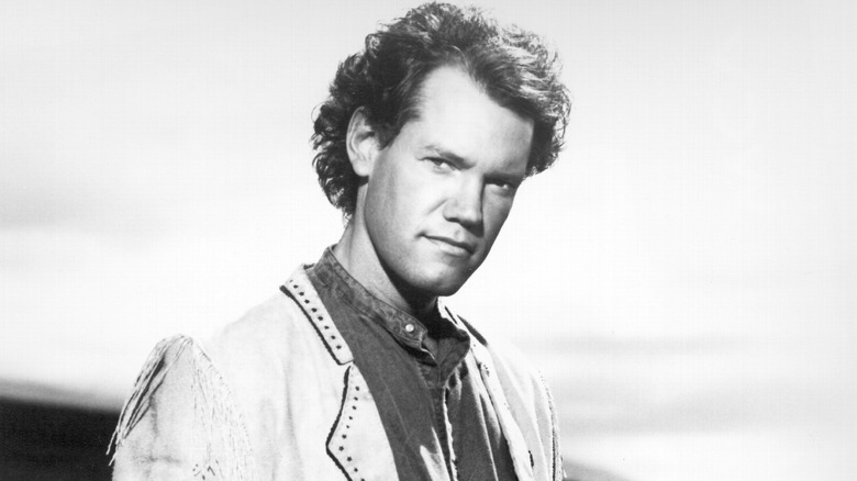 Randy Travis walking and smiling