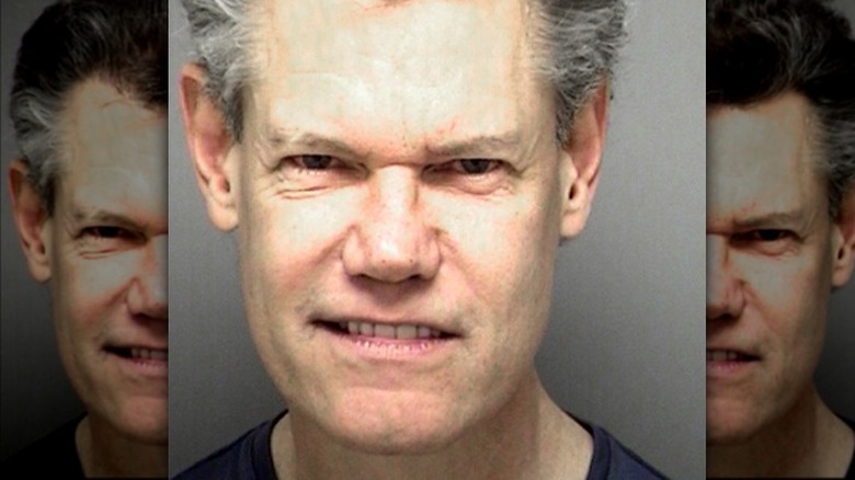 Randy Travis posing for a mugshot