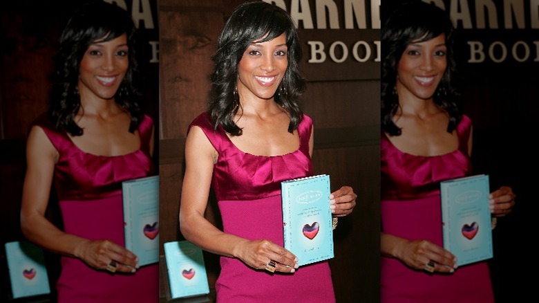 Shaun Robinson shows off her book 