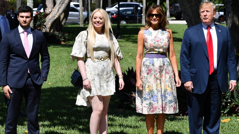 Michael Boulos, Tiffany Trump, Melania Trump, and Donald Trump walking outside