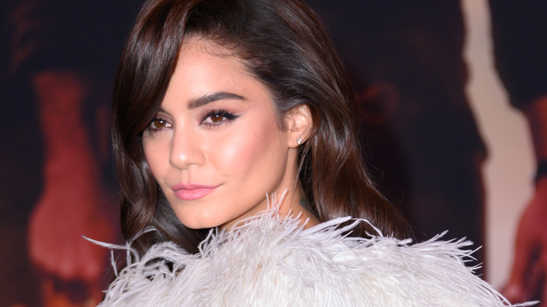 Vanessa Hudgens in feathery top, looking on