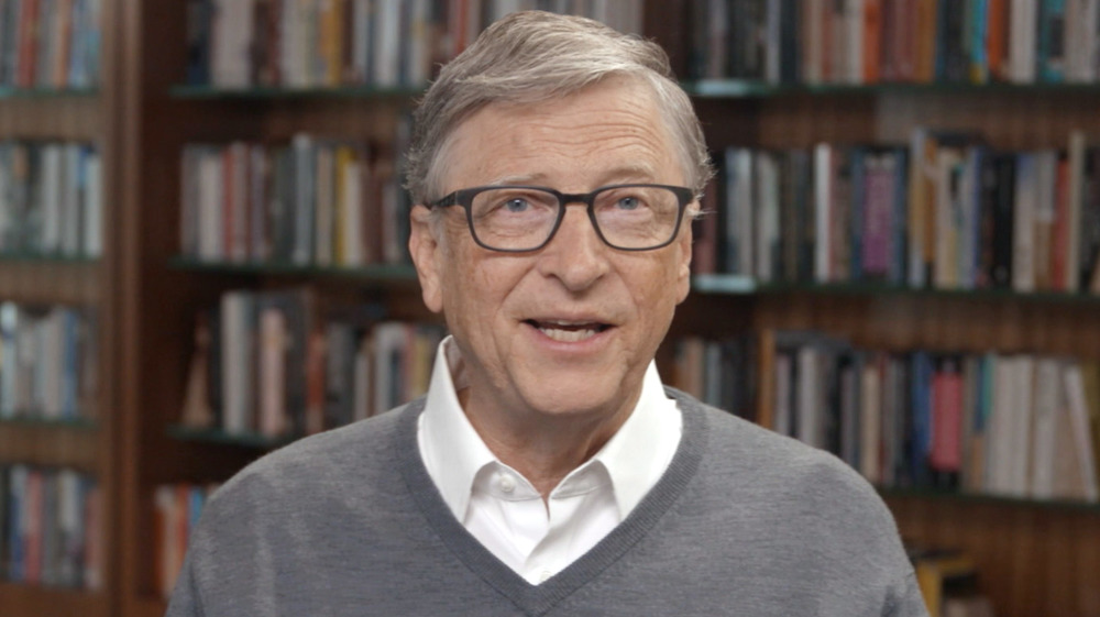 Bill Gates in front of books