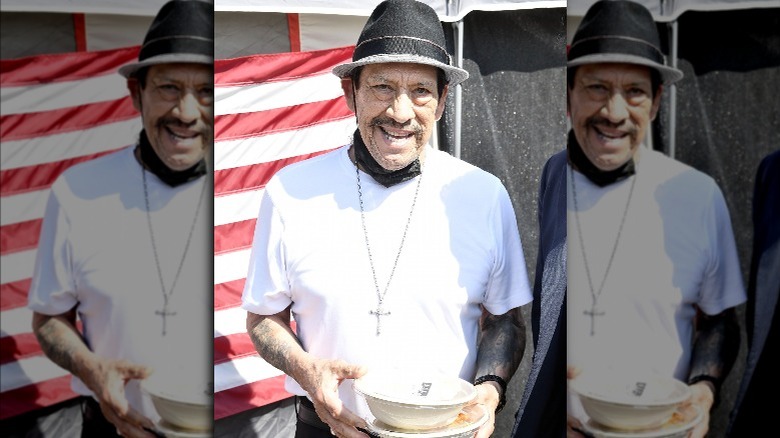 Danny Trejo holding Trejo's Tacos meals