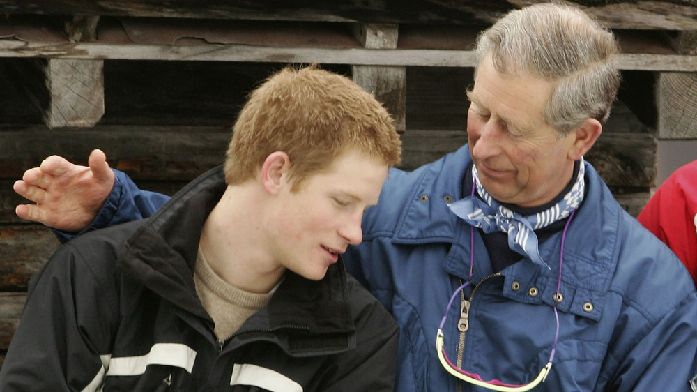 A young Prince Harry getting a pat on the shoulder from Prince Charles