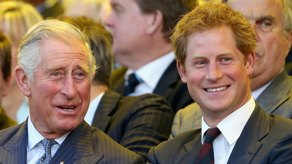 Prince Charles and Prince Harry smiling and laughing 