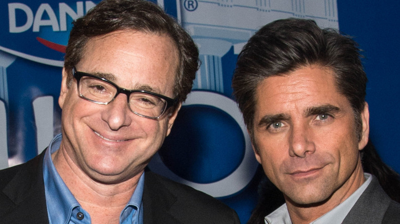 Bob Saget grinning, John Stamos posing