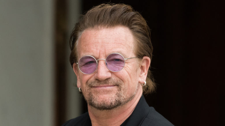 Bono posing with a slight smirk