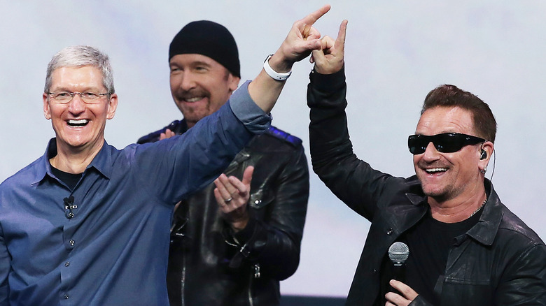 Tim Cook, The Edge, and Bono onstage