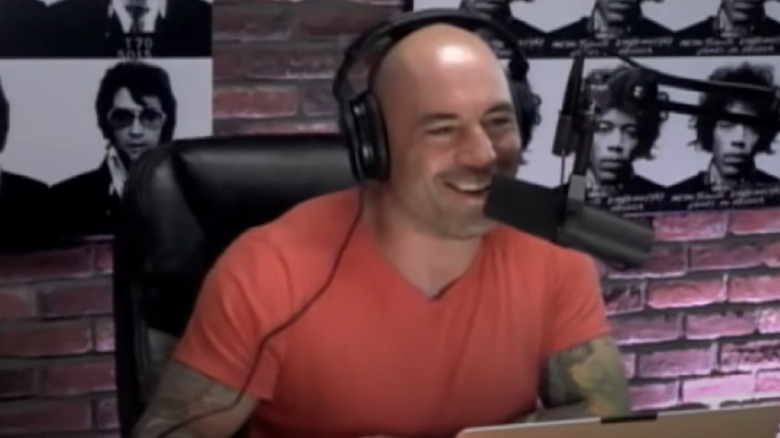 Joe Rogan laughs while podcasting