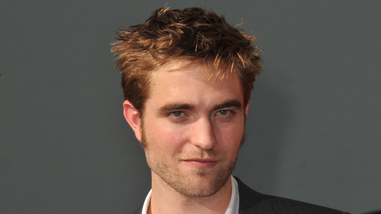 Robert Pattinson smiling slightly