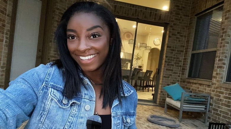 Simone Biles smiling at her new house