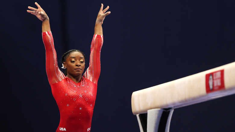 Simone Biles next to the beam