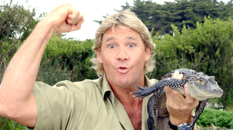 Steve Irwin holding small alligator