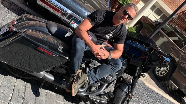 Taylor Kinney sitting on a motorcycle