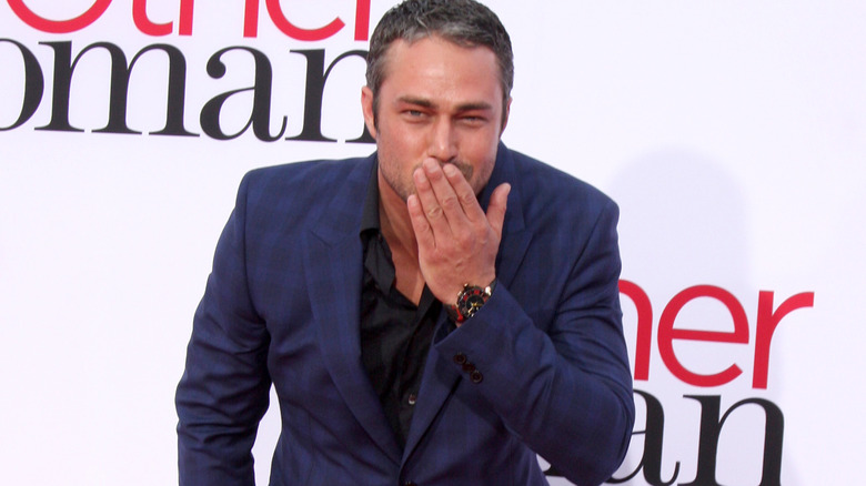 Taylor Kinney blows a kiss