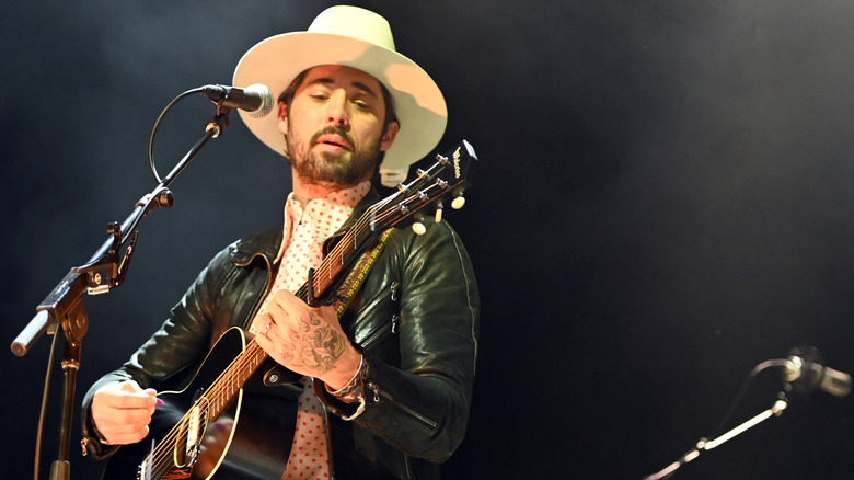 Ryan Bingham performing with guitar