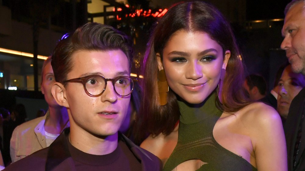 Tom Holland with a shocked expression, Zendaya with a smirk at the Spider-Man: Far From Home premiere