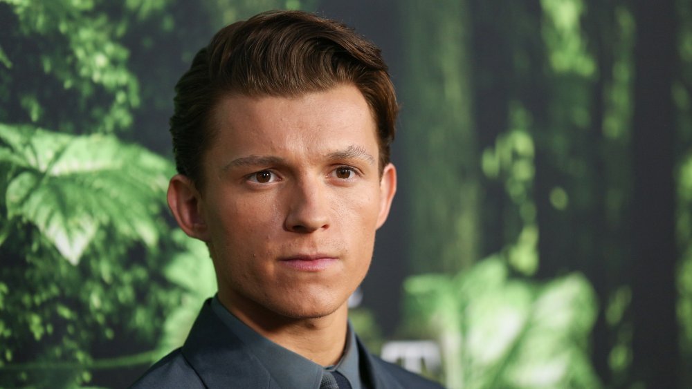 Tom Holland posing with a serious expression at the The Lost City of Z premiere