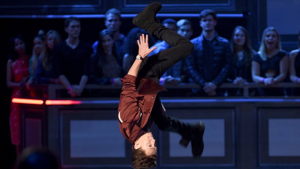 Tom Holland flipping in the air at an awards show