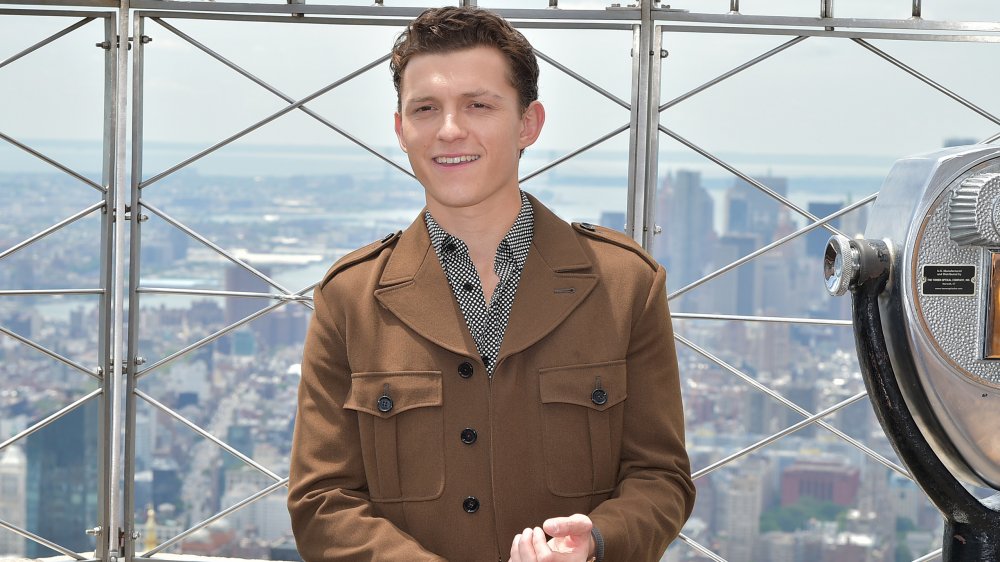 Tom Holland smiling at the top of the Empire State Building