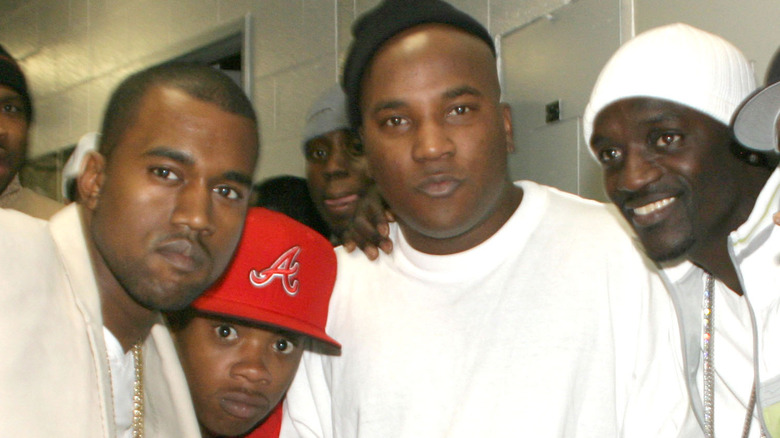 Akon and Kanye West with pals, posing