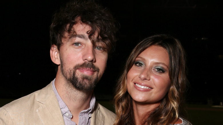 Aly Michalka posing with husband Stephen Ringer