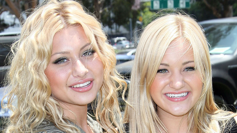 Young Aly and AJ smiling at camera