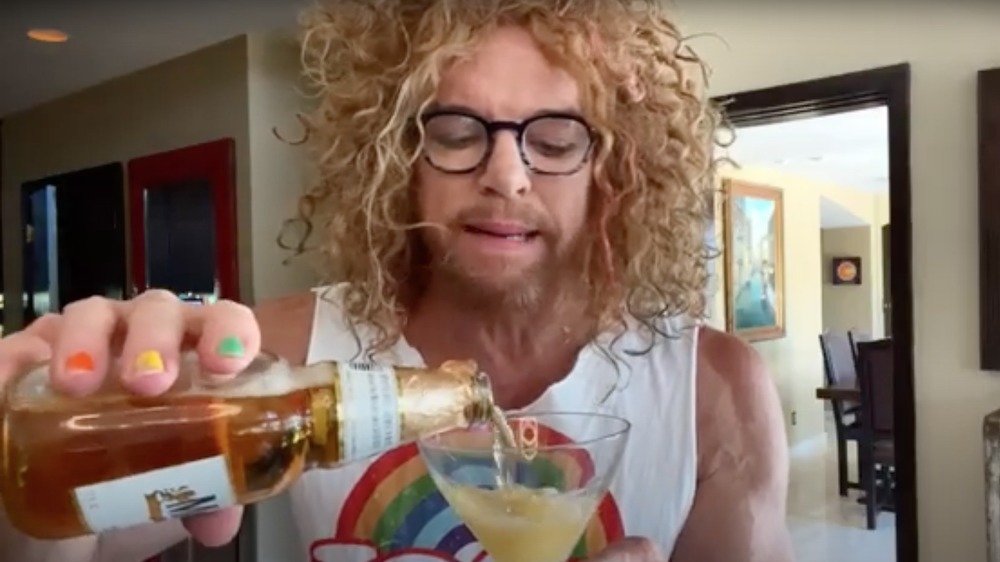 Carrot Top pouring a drink in quarantine