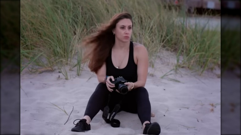 Casey Anthony holding camera on beach